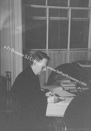 PRIEST AT WRITING DESK